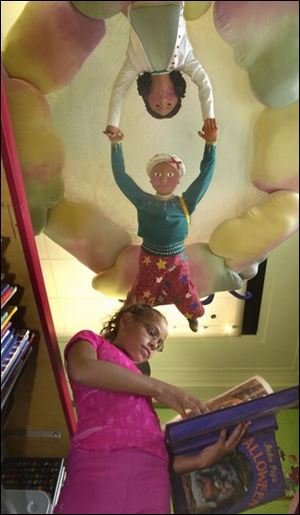Diamond Sierra, 9, reads in the new children's section.