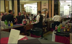 CIRCULATION: Gala guests were checking out liquid refreshments instead of books at the circulation desk.