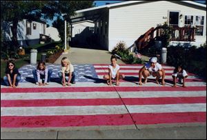 NBR L-R: Kathleen Lascala (glasses), Jessica Dauer, Amanda Ison, Kristen Germain, Autumn Jackson and Chelsey Koder. The girls chalked out a nice design of an American Flag, in their neighborhood using sidewalk chalk. handout photo