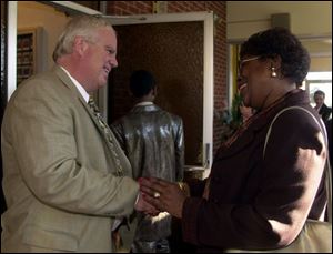 Ray Kest talks to Joyce Mathis before services at the Indiana Avenue Missionary Baptist Church in Toledo. Kest officials believe the African-American vote will be a key to the mayoral contest.