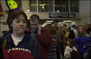 Shannon Kloss and Kyle Dinger, in foreground, wait in the security line after missing their first flight out of Detroit.