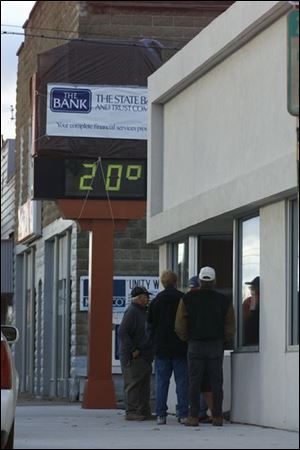 Concerned about their deposits, customers wait outside the Oakwood bank before its opening Monday morning, after it was taken over by State Bank & Trust Co. of Defiance. Mark Steven Miller, the Oakwood bank's chief executive officer, has been charged with bank fraud.