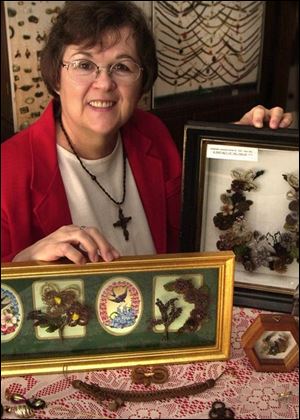 Ruth Gordon displays some of her hairwork. Hair jewelry was popular in America during the 19th century.