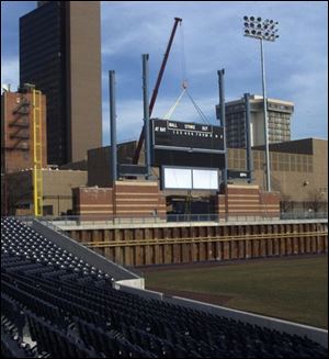 A section of the scoreboard is lowered into place at the Mud Hens' new home, Fifth Third Field.
