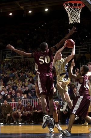 Scott's Derrick Ford blocks a shot by St. John's John Floyd.