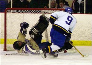 St. John's goalie Jeff Landry sprawls to stop Findlay's Michael Meyers. Landry made 23 saves as the Titans fell in double OT.