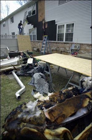 Howard Hart from Quest Construction works on the fire-damaged house in which 8-year-old Joshua Berning died.