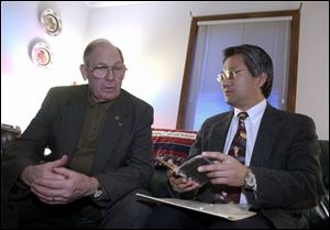 Wayne Matter, left, learns about the diary from Joseph Hara, a professor of Japanese at the University of Toledo who translated portions of it.