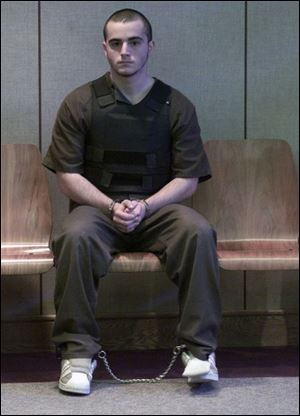 Stephen Everett, 18, is shackled and wearing a bullet-proof vest as he ap- pears in Oregon Municipal Court on charges that he killed Rhonda Douglas.