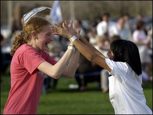 CTY israel17p 041702 B  April 17, 2002--Rebecca Federman, left, and Mayaan Beckerman have fun playing together at Jewish Community Center during a celebration and solidarity rally on the 54th anniversary of the state of Israel. The two 12 year-olds were part of a crowd of 500 people participating in Wednesday night's event sponsored by the JCC and the United  Jewish Council. Blade photo by Andy Morrison