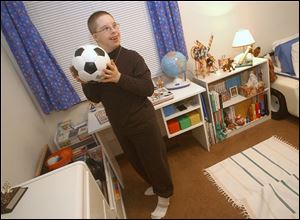 Aaron Bar, 13, at his home, is able to walk again as a result of corrective surgery through the Shriners organization.