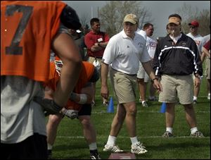 Linebackers coach John Bowers, center, and defensive coordinator Tim Beckman run the Falcons through drills in preparation for the spring game tomorrow at 1 p.m. in Perry Stadium.