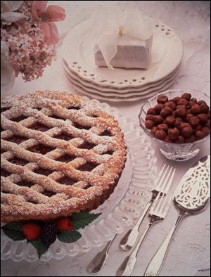 Blackberry Raspberry Linzertorte features a sugar-dusted lattice top over a sweet filling.