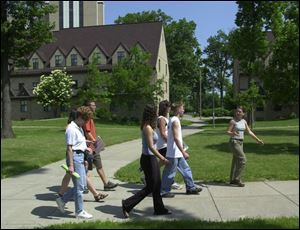 Abi Good, right, leads a group of incoming freshmen and potential students on a tour of the University of Toledo.