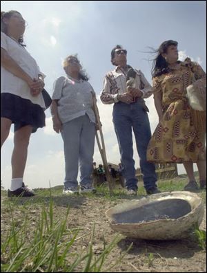 From left, Conception Flores, Robert Tallbird, and Joyce Mahaney of the American Intertribal Association conduct a ritual purification of Native American burial sites that were discovered at Fort Meigs.