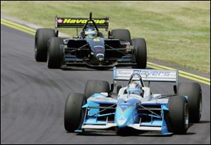 Eventual winner Patrick Carpentier passes pole-sitter Cristiano da Matta early in the Marconi Grand Prix of Cleveland. Da Matta was forced out with mechanical problems on the 22nd lap.