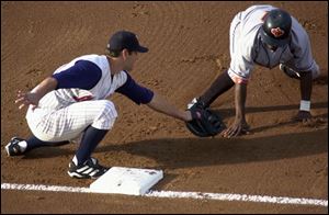 Hens first baseman Eric Munson catches Eddy Garabito off first during a first-inning steal attempt. Munson chased and tagged Garabito after the pick-off throw by Pat Ahearne.