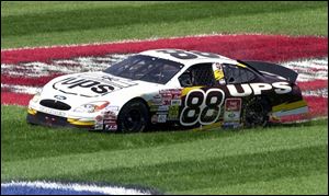 Dale Jarrett regains control after spinning out on turn 4 at Michigan International Speedway yesterday in the NASCAR Pepsi 400. He slid about 200 yards through the grass, pitted for maintenance and came back from 39th place to win.