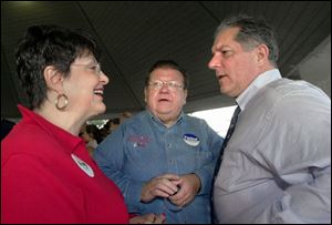 Sandy Isenberg, Peter Ujvagi, and gubernatorial candidate Tim Hagan chat as local Democrats hold their annual get-together at International Park.