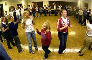 Students and their families from Whitmer High School welcome German exchange students with dinner and dancing at First Congregational Church in Toledo.