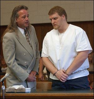 Tazwell Lomax confers with his attorney, Adrian Cimerman, during the court hearing.