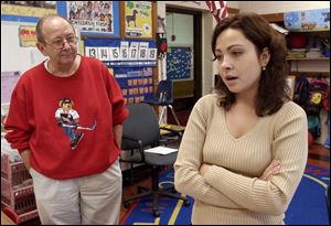 Colleen Buscemi, who was aboard the bus when it was struck by a tractor-trailer rig, discusses the accident as the school's principal, James Bouvy, listens in.