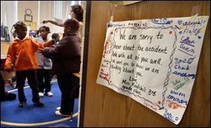 A sign from a third-grade class at a nearby school offers support to the first-grade students.