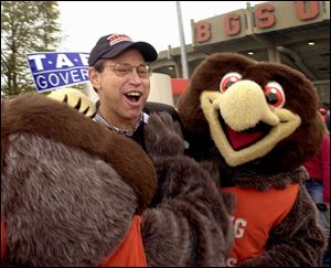 Gov. Bob Taft, decked out in Bowling Green State University paraphernalia, is greeted by BGSU mascots Frieda and Freddy as he arrives to attend a football game.