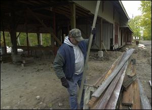 Dale Klingensmith of Brackenridge Construction works on the former railroad depot being restored as a community center in Lakeside, Ohio. Plans call for the project to be completed by the summer.