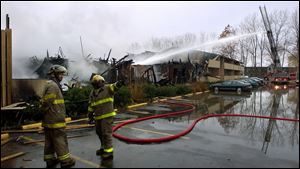 Firefighters work to extinguish an early morning blaze at University Circle Apartments, 3414 Dorr St., near the school's Bancroft Street campus. Scores of students were left homeless.