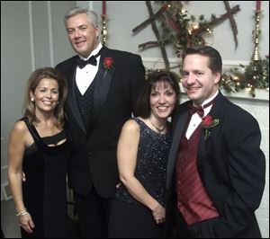 'HOLLY BALL:' Sponsors Renee and Bob Huebner and Amy and John Spengler enjoy the evening's events. Couples danced past midnight after a stately dinner.