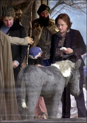 ROV wise 01 - 121202 - L-R, Sandy Guiliani and Linda Benham, who are employees of Finkbeiner, Pettis and Strout, tend to the Three Wise Men in the window display which is part of the Downtown Wonderland along Jackson St. The Blade/Allan Detrich