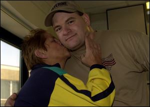 Rosalie Miller gives her son, Todd, a kiss at Medical College of Ohio Hospitals. Todd donated one of his kidneys to his mother with the help of a city benefit that gives employees six weeks off with pay when they donate an organ.