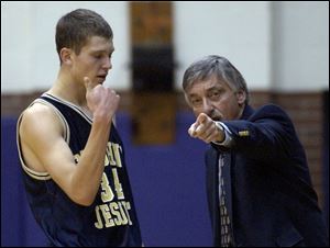 St. John's coach Ed Heintschel directs Zach Hillesland, who had 13 points in a 79-52 win over Woodward.