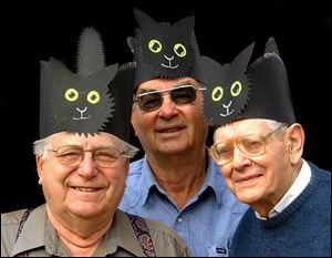 The 13 members of the Black Cat Club in Spencerville, west of Lima - including, from left, Robert Redick, Jim Koenig, and Bill Foster - have been getting together every Friday the 13th to thumb their noses at superstition.