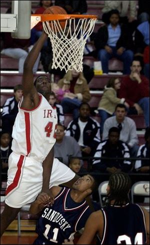 Central Catholic's Chris Commons scores over Sandusky's Greg Garrett, center, and Nate Matthews.