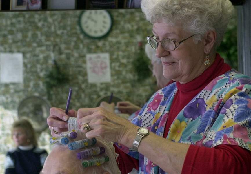 Starr-Avenue-beautician-puts-away-scissors-and-brushes