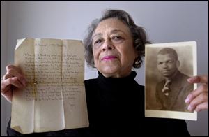 Dorothy Smith holds one of the poems written by her late husband, Jon Smith, and an early photo of him. She says his writing was 'almost like Keats and Shelley.'