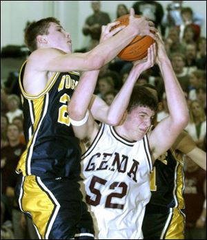 Woodmore's Tyler Rosenberger and Genoa's Zach Diekman battle for a rebound during the second quarter. Rosenberger, a sophomore, had 20 points and eight rebounds. Diekman, a 6-8 junior, had 14 points and 16 rebounds. 