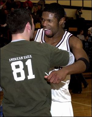 Rossford senior Darren Paige (24 points) celebrates the Bulldogs' upset victory over Fostoria.