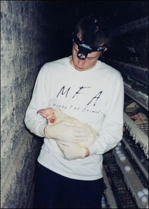 Nathan Runkle holds the hen he says he saved from the trash can.