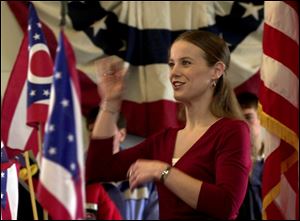 Lorraine Mackey, Clyde High School choir director, leads the a cappella choir in `Beautiful Ohio' during the opening ceremony for festivities in Clyde. Donations helped the town put on the event.