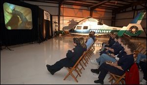 Emergency personnel watch the program at the Sandusky County Regional Airport.