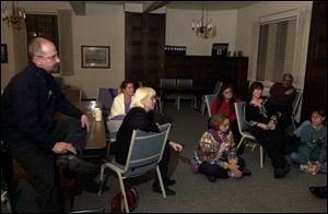 Amjad Doumani, left, joins other peace activists at St. Mark's Episcopal Church in discussing the start of war with Iraq.