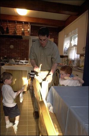 Cantor James Gloth and sons Micah, 2, at left, and Avi, 4, search the house for leavened bread.