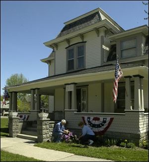 Bob and Sherry Bauer, working in their yard, bought Dr. Paul Allman Siple's former home on Empire Street and have spent nearly two years restoring its wooden floors and uncovering its high ceilings.