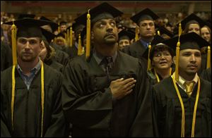 Matthew Miller of Curtice, Andre Jackson of Toledo, and Jeremy Gonzalez of Fremont, from left, wait to be presented their associate degrees in technical studies from Owens.
