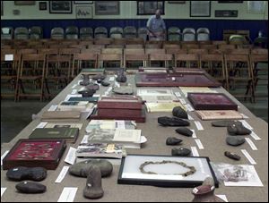 The Indian artifacts are sorted on a table, awaiting the auction on Saturday.