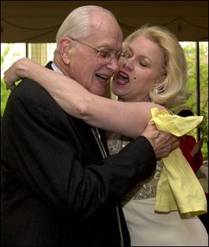 BIRTHDAY HUG: Museum docent Charles Russell gets a hug from a Marilyn Donahue, as Marilyn Monroe.