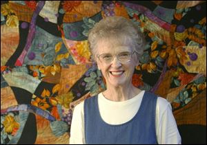 `My work stands up alongside painting and sculpture,' says self-described `fiber artist' Joan Rigal, with one of her creations at the studio in her home in Waterville.